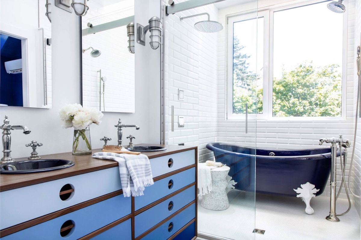 Kék lábas kád és ipari hangulatú fürdőszobai szekrény