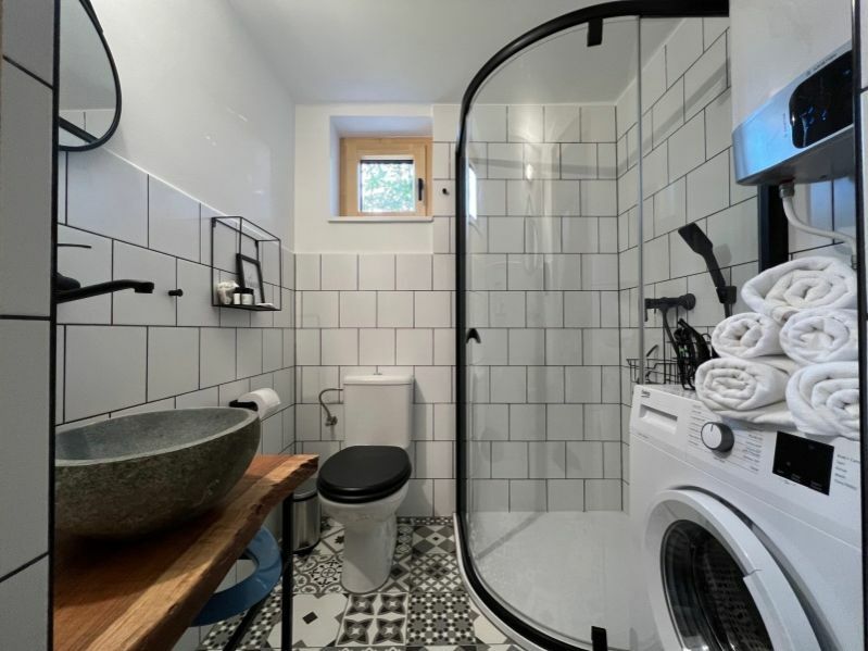 Modern fürdőszoba fehér csempe és cementlap mintás burkolat